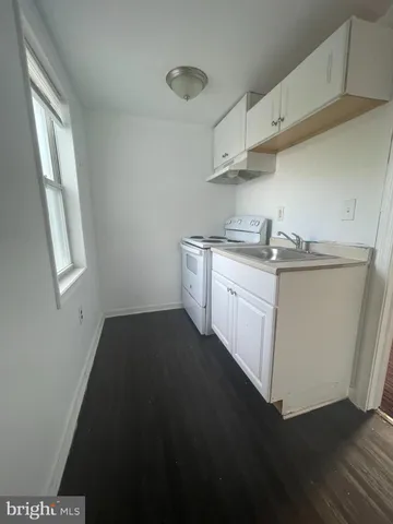 a bathroom with a sink and a black white checkered floor