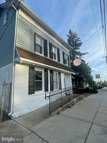 a view of a house with a small yard