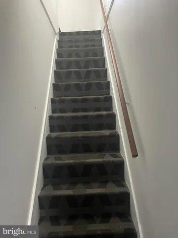 a view of staircase with white walls