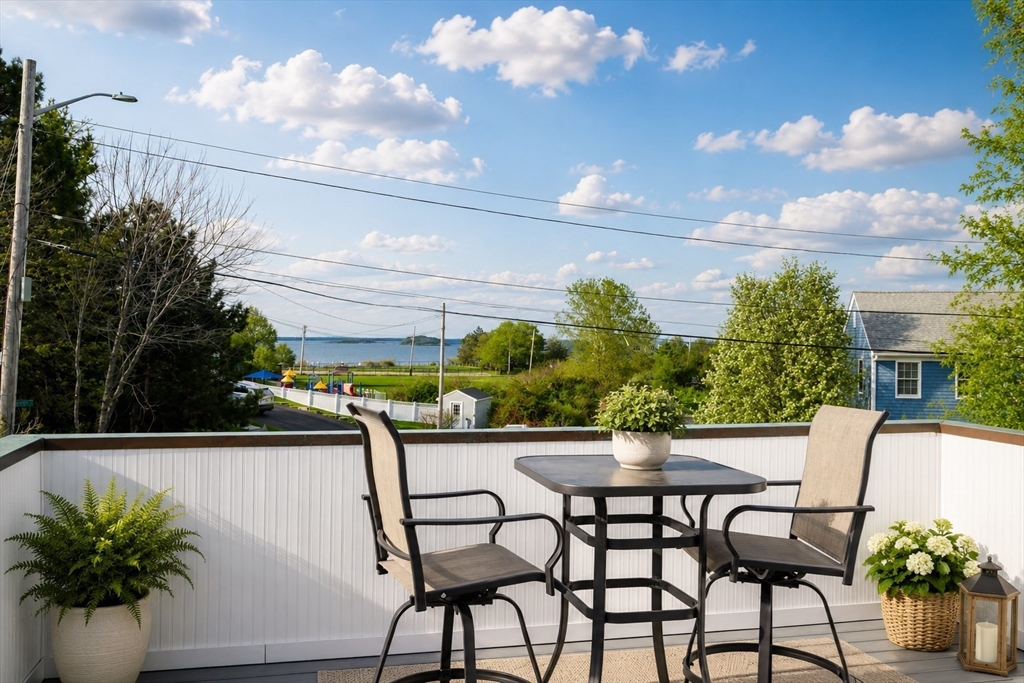 4 Harborview Road Hull, MA 02045 - Photo 16 of 38 a view of a chairs and table in a backyard