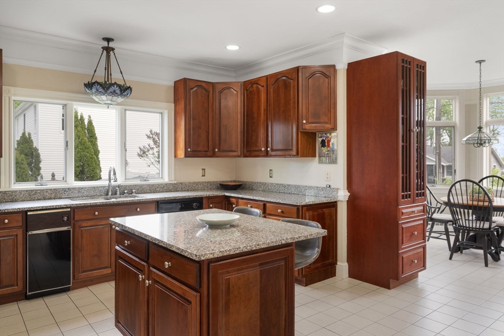 4 Harborview Road Hull, MA 02045 - Photo 5 of 38 a kitchen with stainless steel appliances granite countertop a stove refrigerator and cabinets