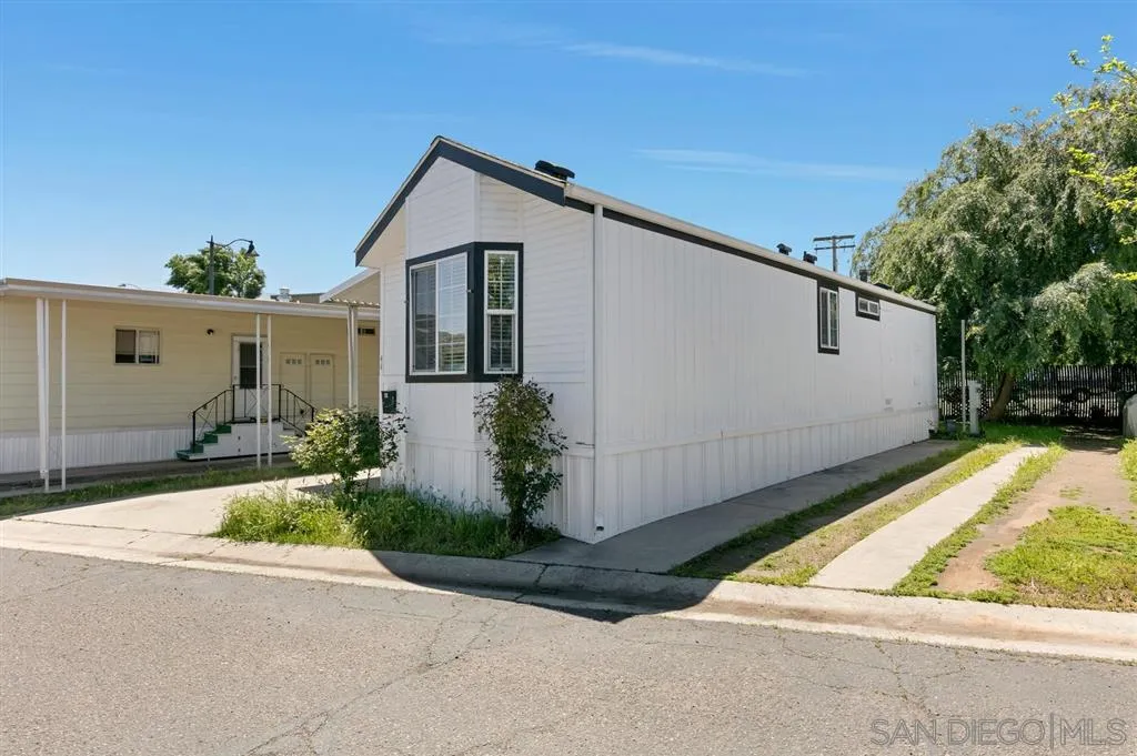 10250 Prospect Avenue, Unit 44 Santee, CA 92071 - Photo 3 of 17 a view of house with backyard and bushes