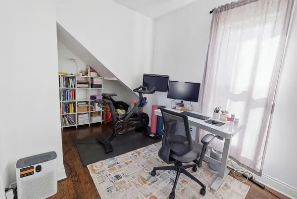 a view of a dining room with furniture and wooden floor
