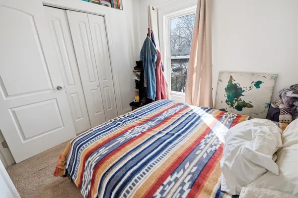 a bathroom with a granite countertop sink toilet a mirror and vanity