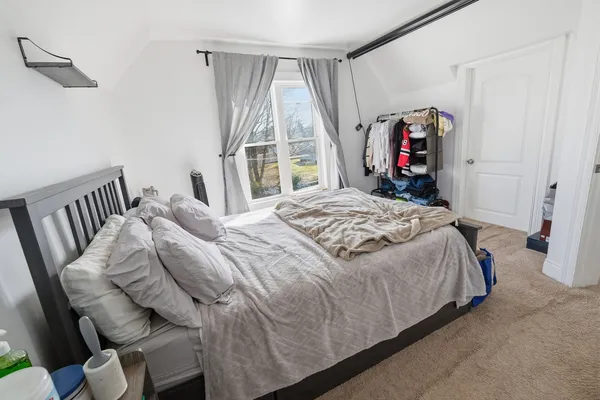 a bathroom with a granite countertop sink a mirror and a shower