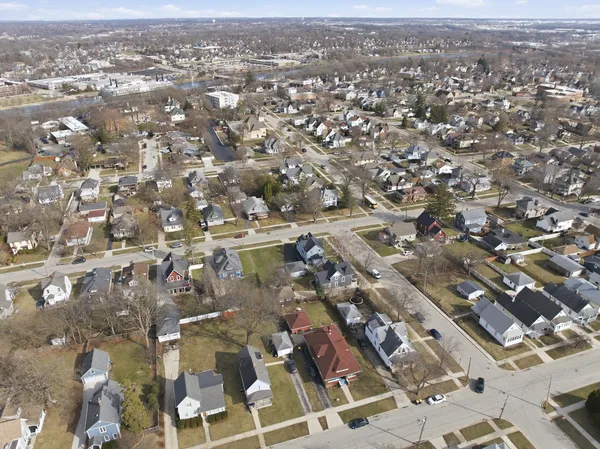 an aerial view of houses with a lake