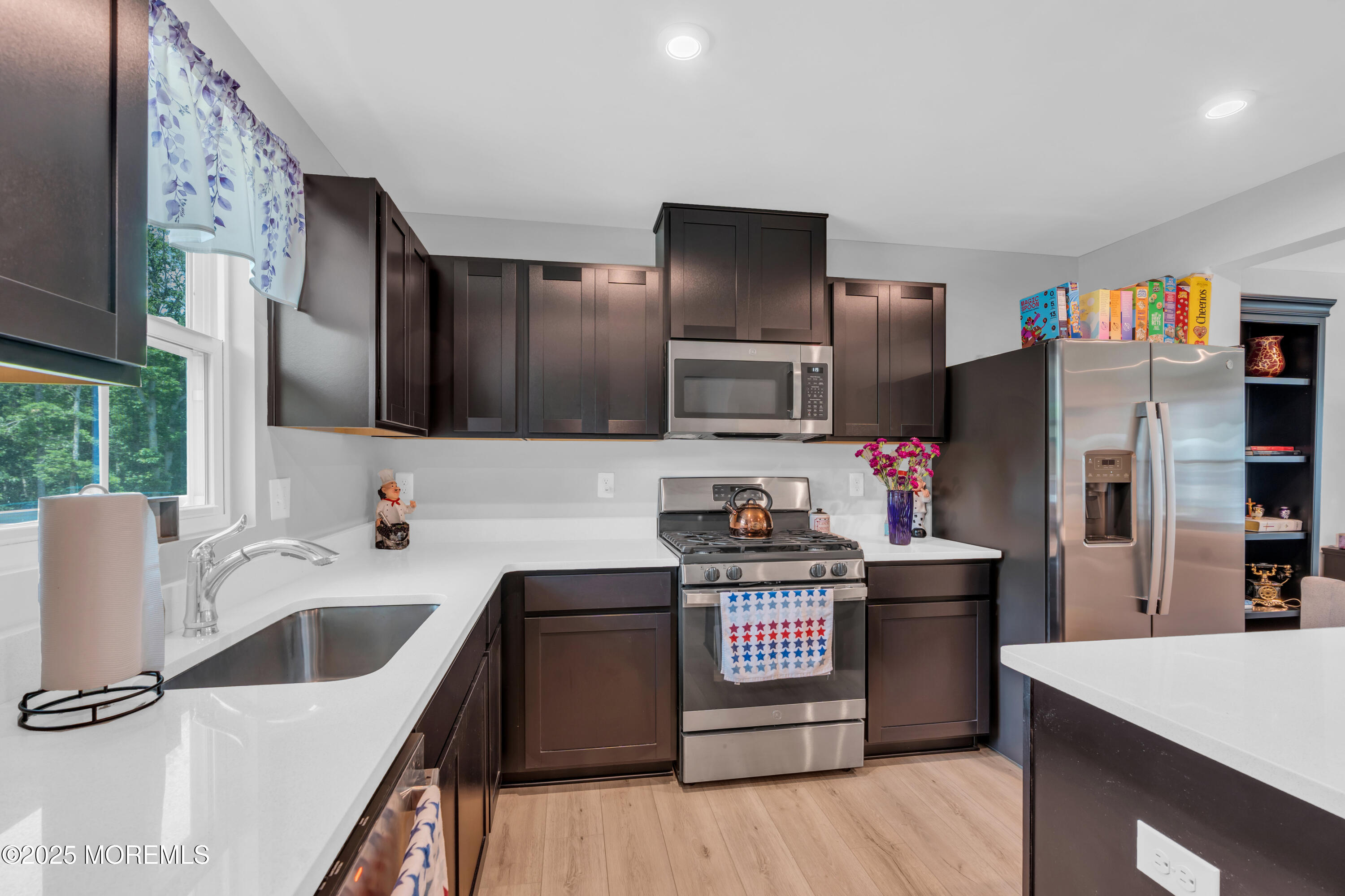 703 Cypress Street Forked River, NJ 08731 - Photo 12 of 50 a kitchen with stainless steel appliances kitchen island granite countertop a sink stove and refrigerator