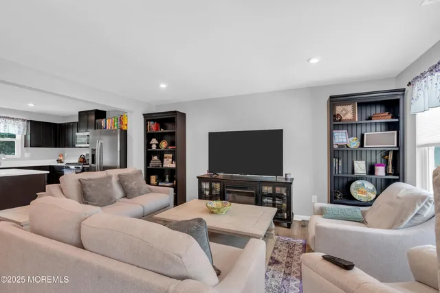 a living room with furniture a rug and a flat screen tv
