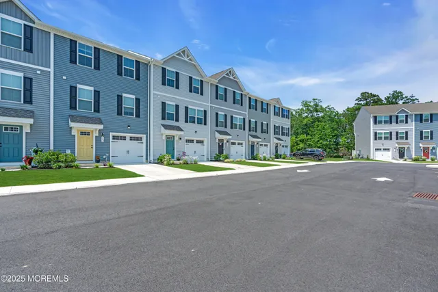 a front view of a house with yard and green space