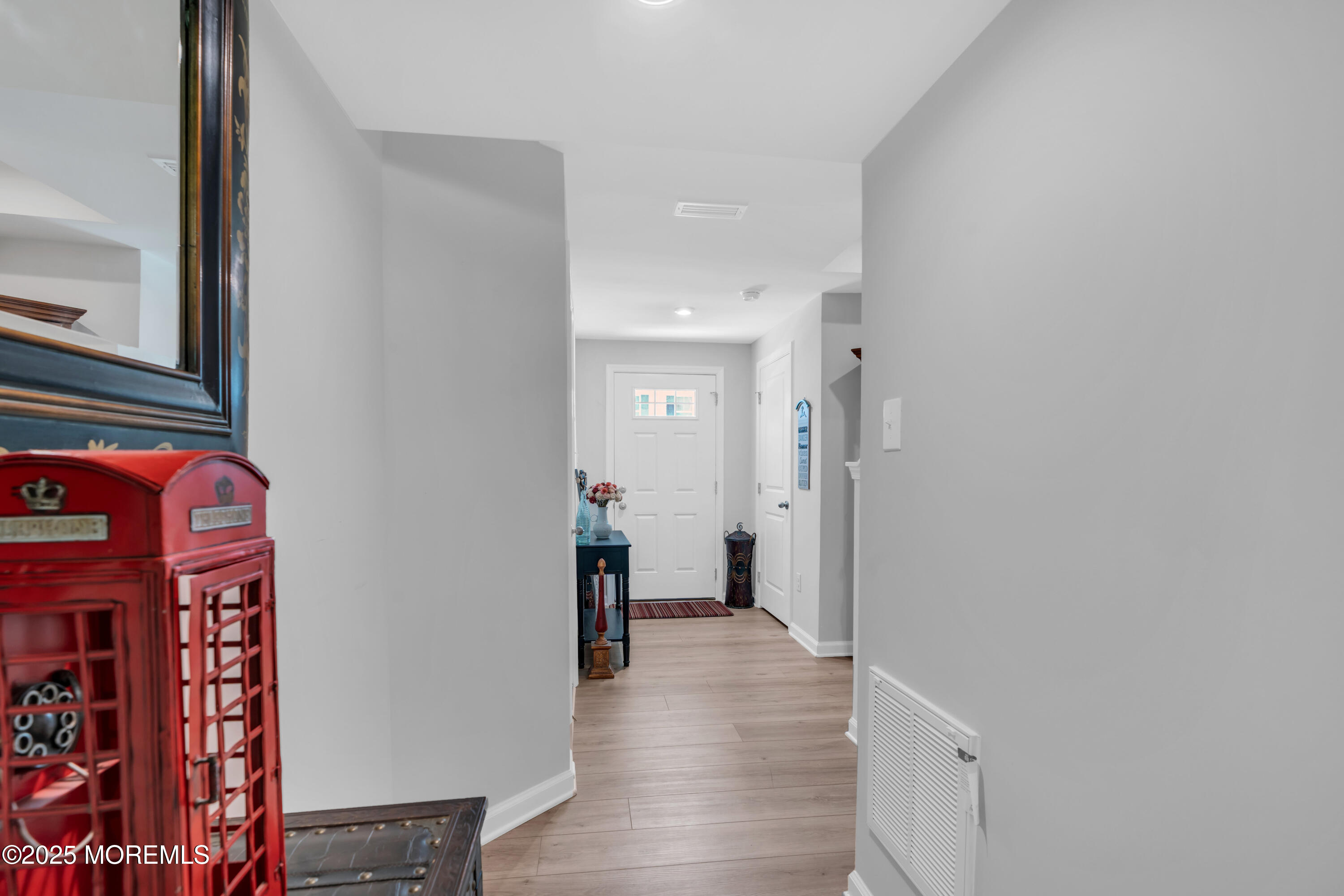 703 Cypress Street Forked River, NJ 08731 - Photo 8 of 50 a view of a hallway with wooden floor and closet