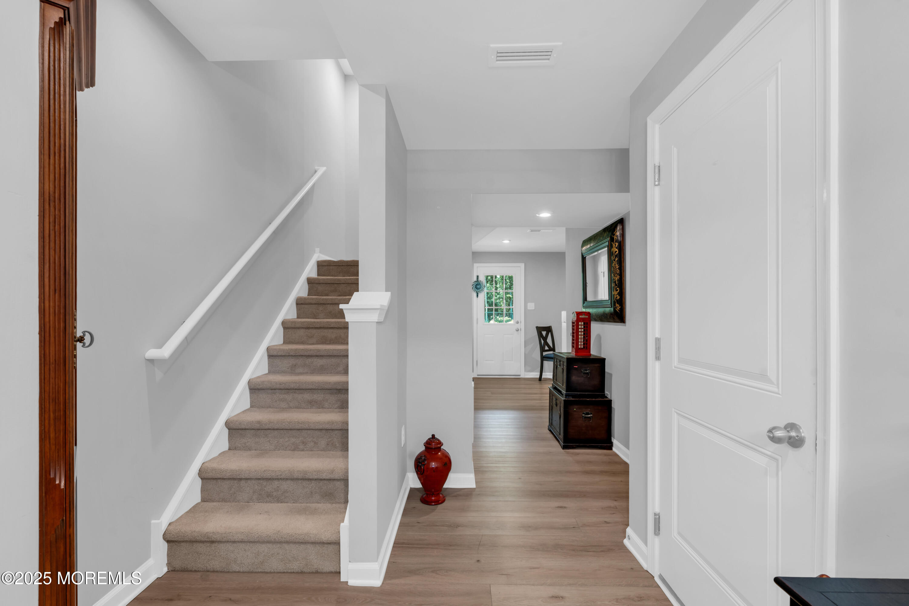 703 Cypress Street Forked River, NJ 08731 - Photo 10 of 50 a hallway view with staircase and a living room