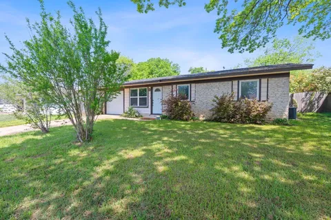 a view of house with yard and green space