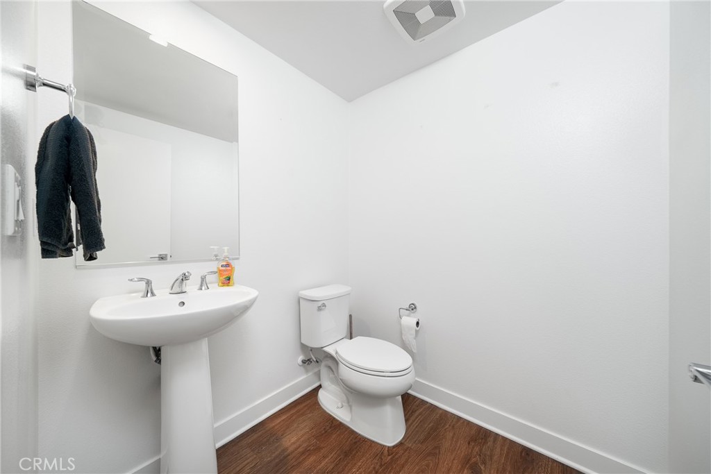 1602 West Bushell Street Anaheim, CA 92805 - Photo 18 of 31 a bathroom with a sink mirror and toilet