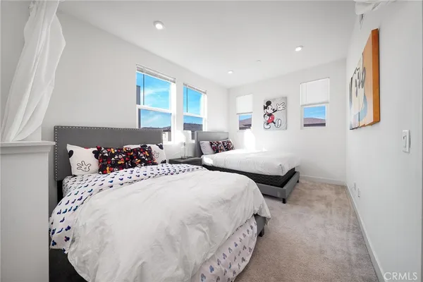a bedroom with two beds and a dresser