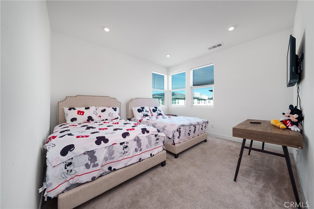 1602 West Bushell Street Anaheim, CA 92805 - Photo 21 of 31 a bedroom with a bed and a chair in it