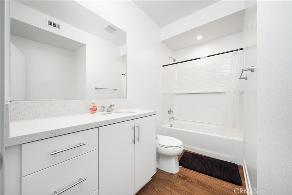 1602 West Bushell Street Anaheim, CA 92805 - Photo 25 of 31 a bathroom with a bathtub shower sink vanity and toilet