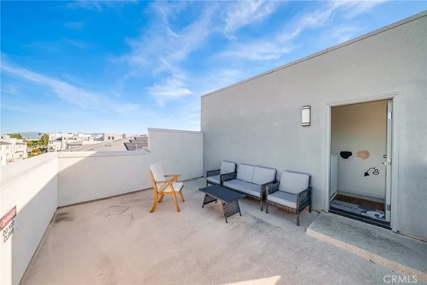 a view of a chairs and table in a balcony