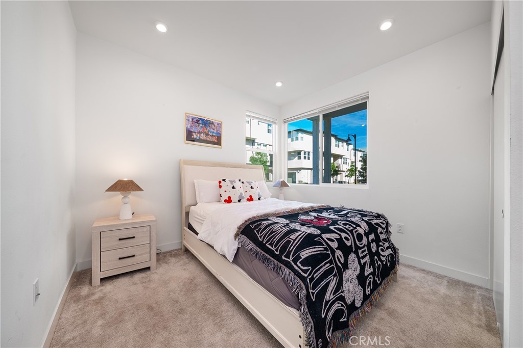 1602 West Bushell Street Anaheim, CA 92805 - Photo 8 of 31 a bedroom with a bed and a window