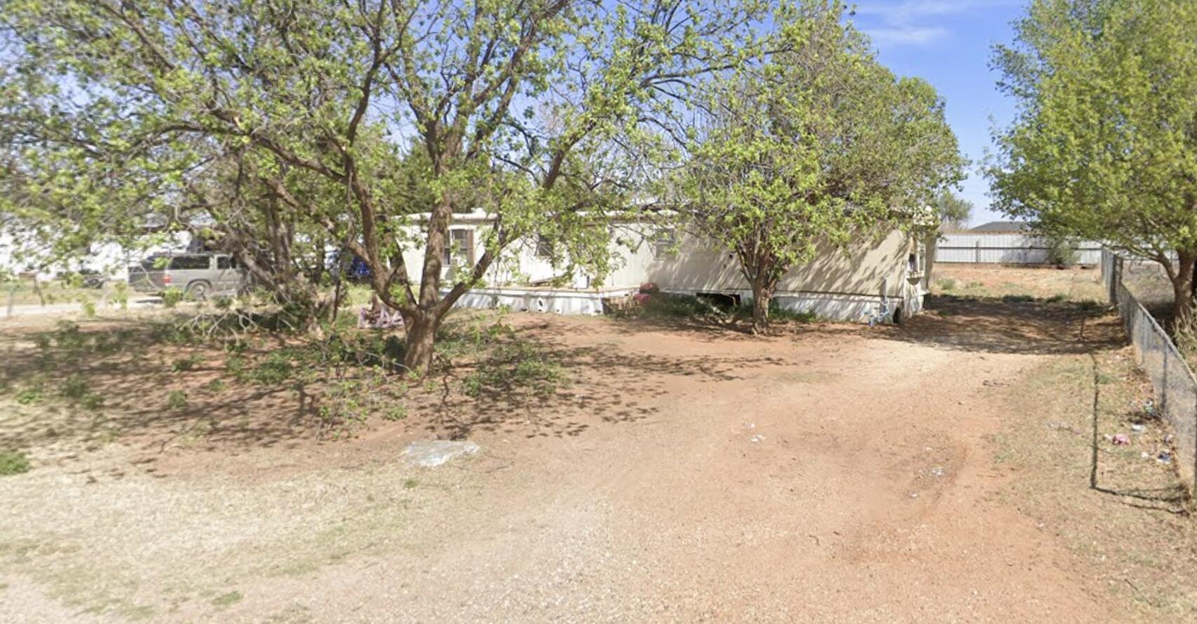 a view of empty space with large trees
