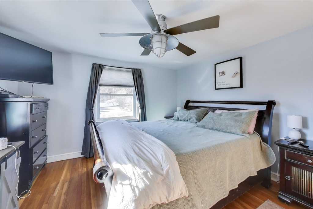 76 Dale Street Boston, MA 02131 - Photo 14 of 29 a bedroom with a bed and a flat screen tv