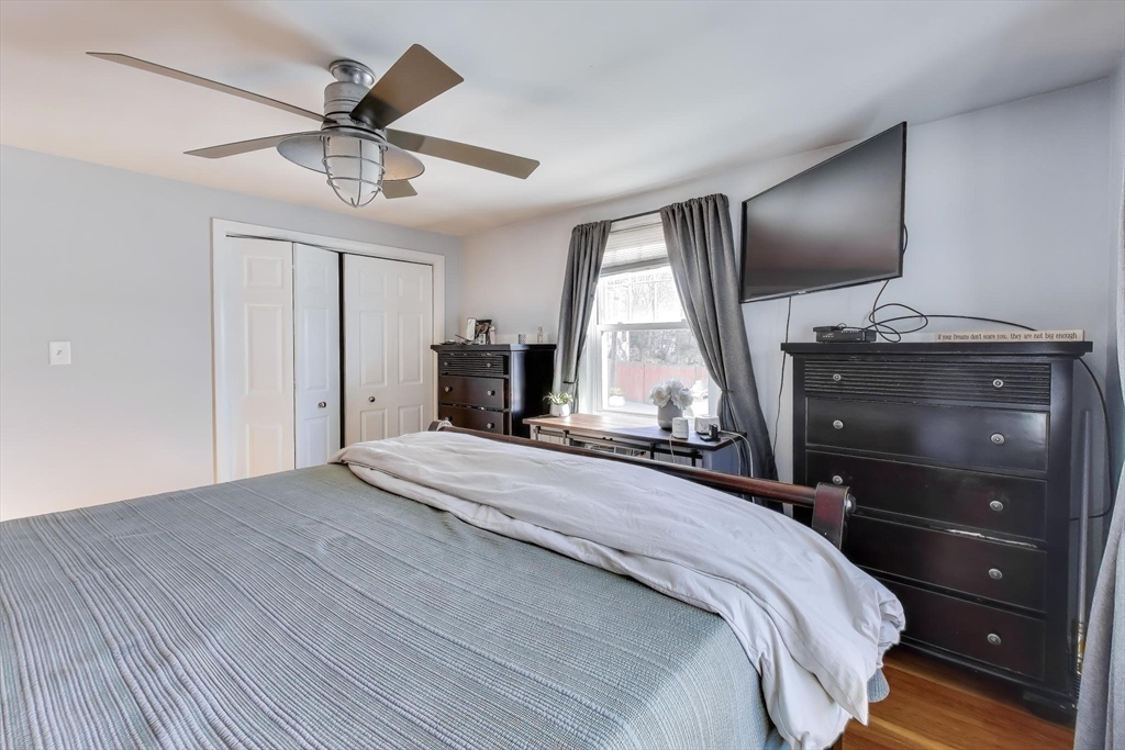 76 Dale Street Boston, MA 02131 - Photo 15 of 29 a bedroom with a bed and a chandelier