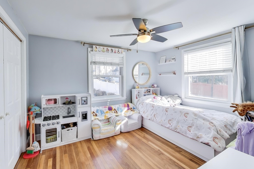76 Dale Street Boston, MA 02131 - Photo 16 of 29 a bedroom with furniture and a wooden floor