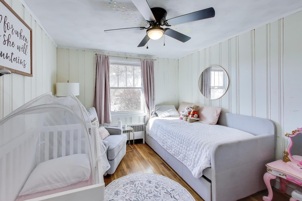 76 Dale Street Boston, MA 02131 - Photo 18 of 29 a bedroom with a bed and a chandelier