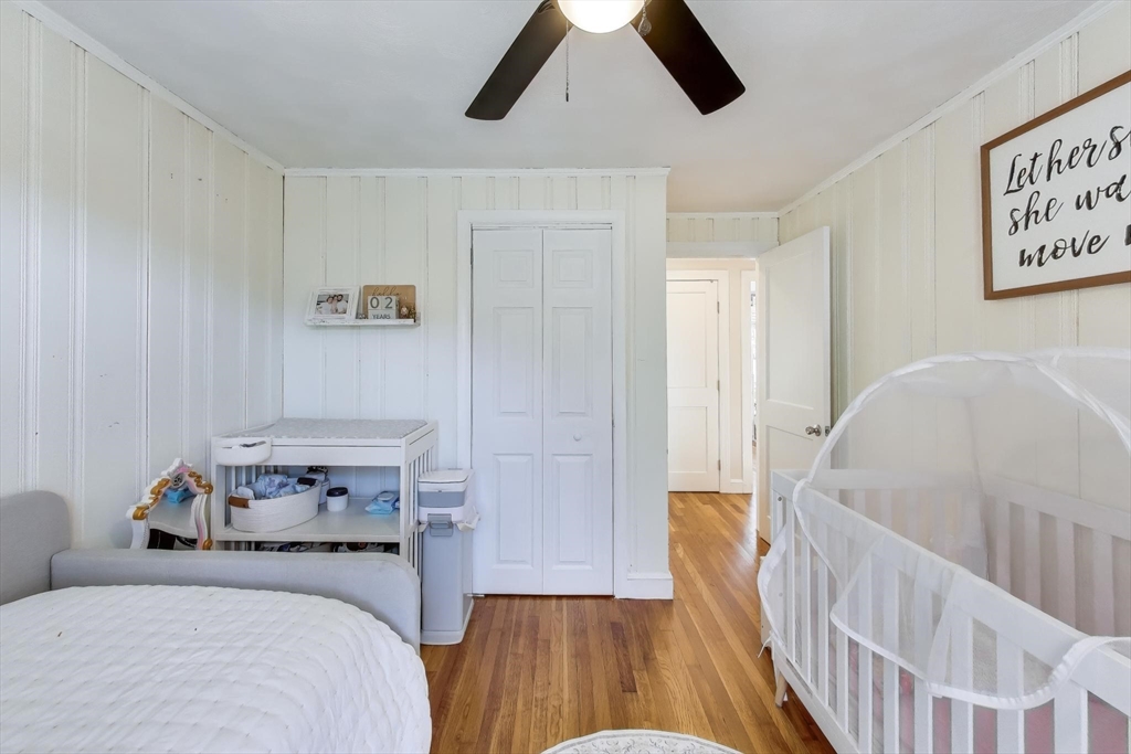 76 Dale Street Boston, MA 02131 - Photo 19 of 29 a bedroom with a bed and wooden floor