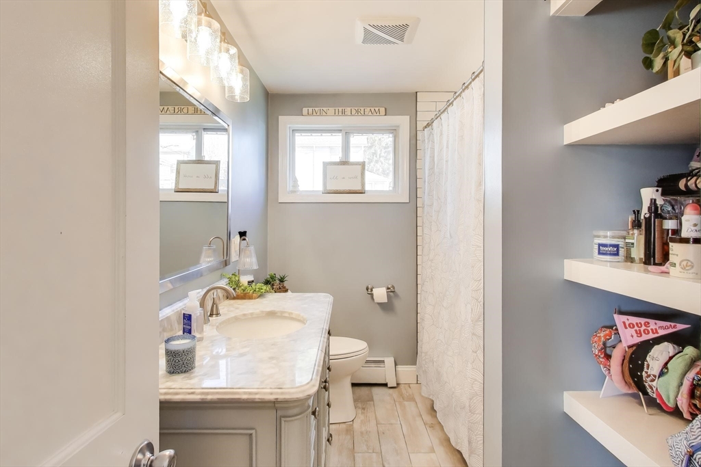 76 Dale Street Boston, MA 02131 - Photo 20 of 29 a bathroom with a sink toilet and a mirror