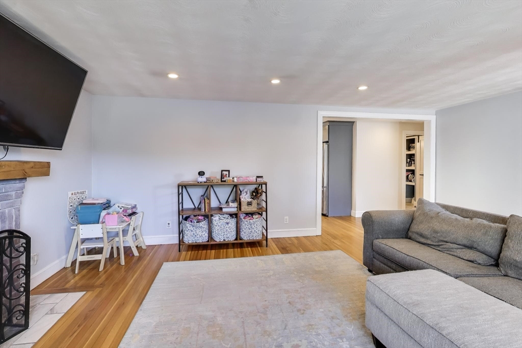 76 Dale Street Boston, MA 02131 - Photo 10 of 29 a living room with furniture and a flat screen tv