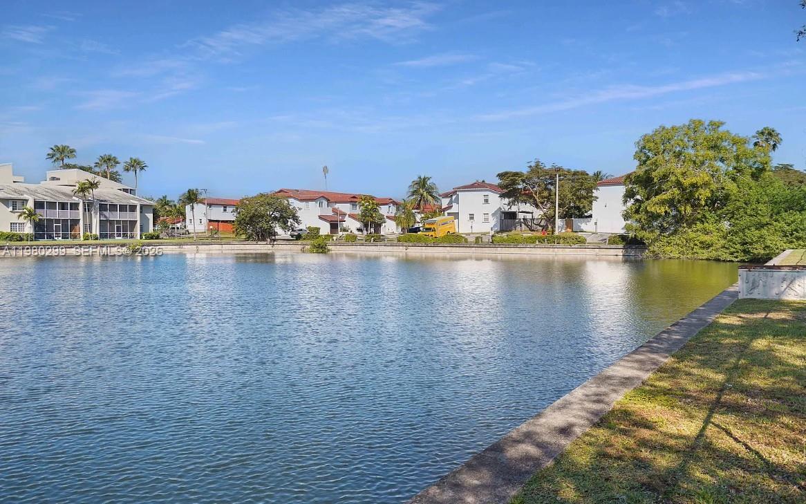 8260 Southwest 210th Street, Unit 302 Cutler Bay, FL 33189 - Photo 12 of 42 a view of a lake with a house