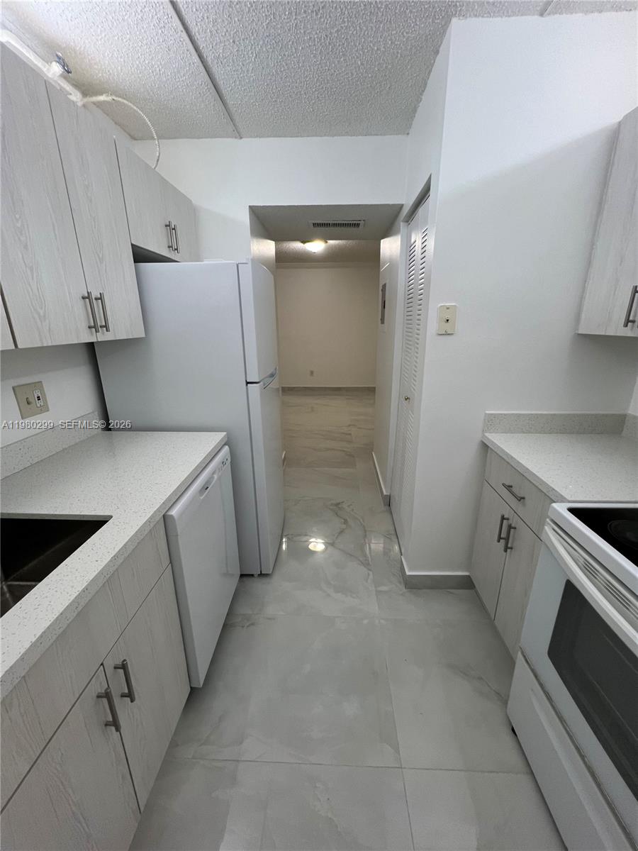 8260 Southwest 210th Street, Unit 302 Cutler Bay, FL 33189 - Photo 20 of 42 a view of a kitchen with storage and utility