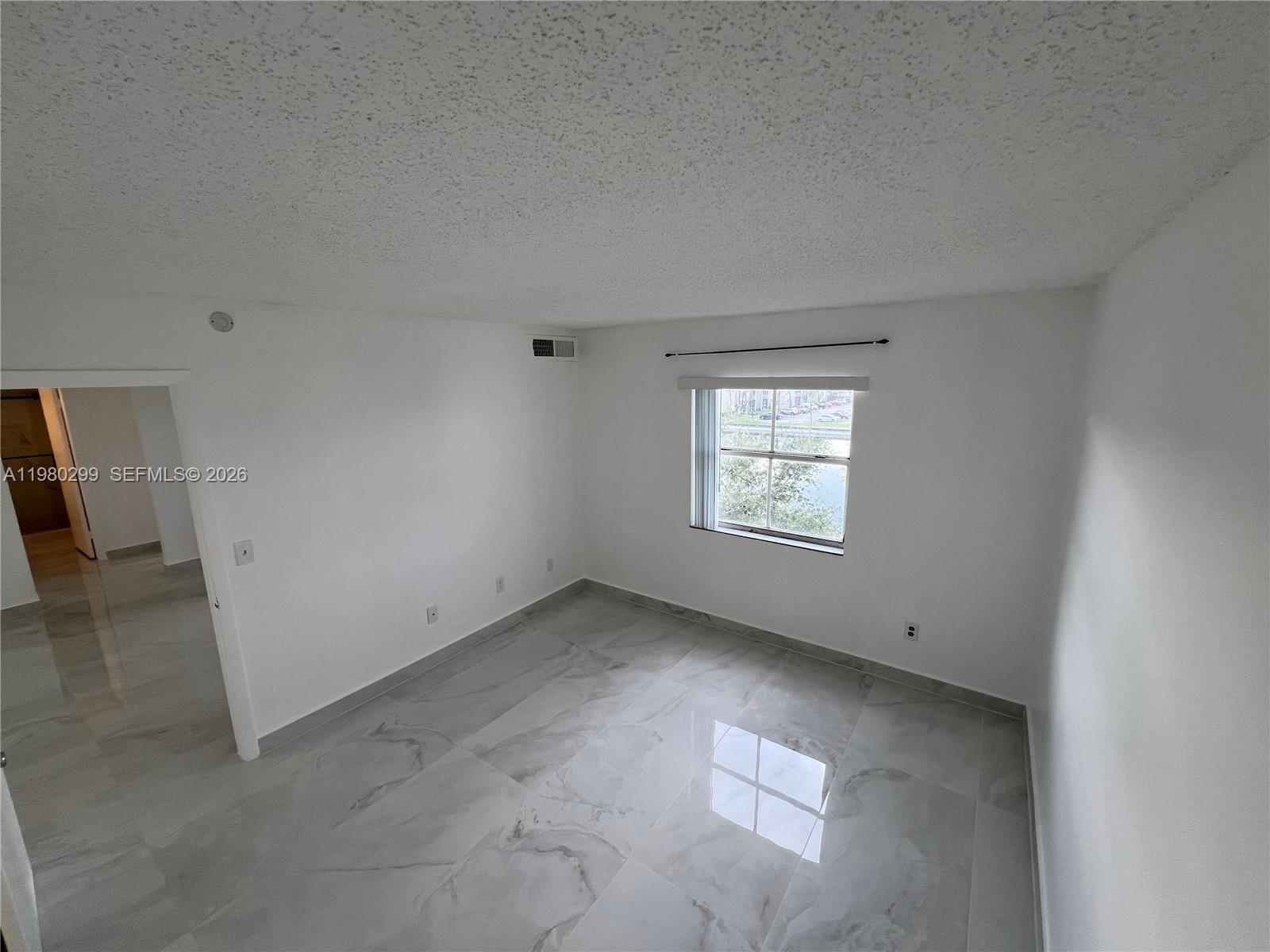 8260 Southwest 210th Street, Unit 302 Cutler Bay, FL 33189 - Photo 30 of 42 an empty room with windows