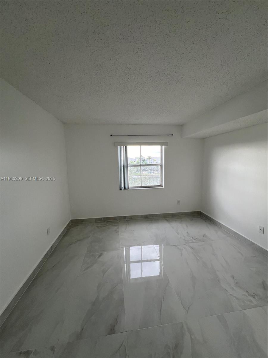 8260 Southwest 210th Street, Unit 302 Cutler Bay, FL 33189 - Photo 31 of 42 an empty room with a window