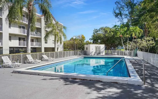 a view of pool with a yard