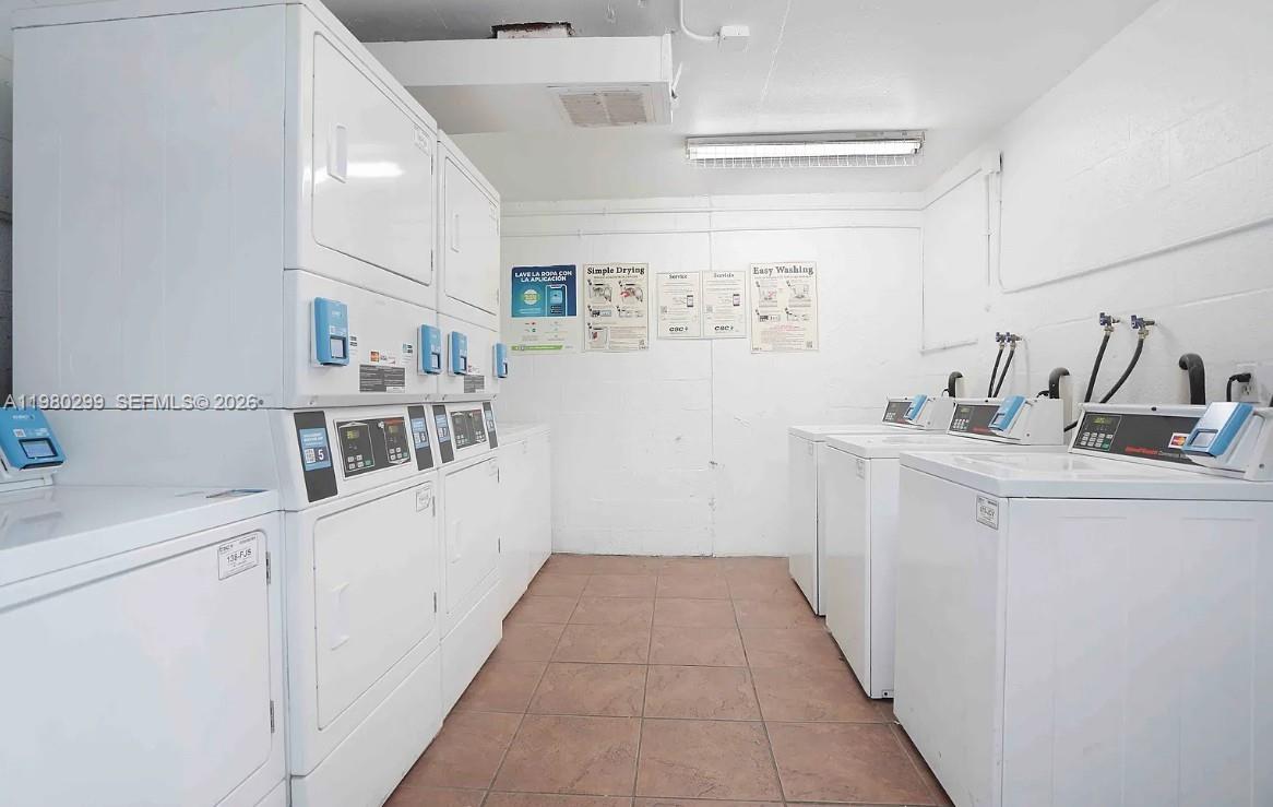 8260 Southwest 210th Street, Unit 302 Cutler Bay, FL 33189 - Photo 9 of 42 a utility room with cabinets washer and dryer