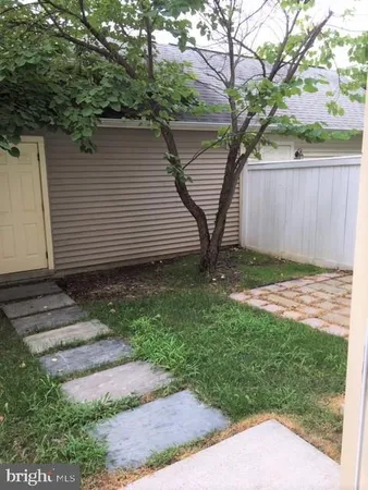 a view of a backyard with a tree