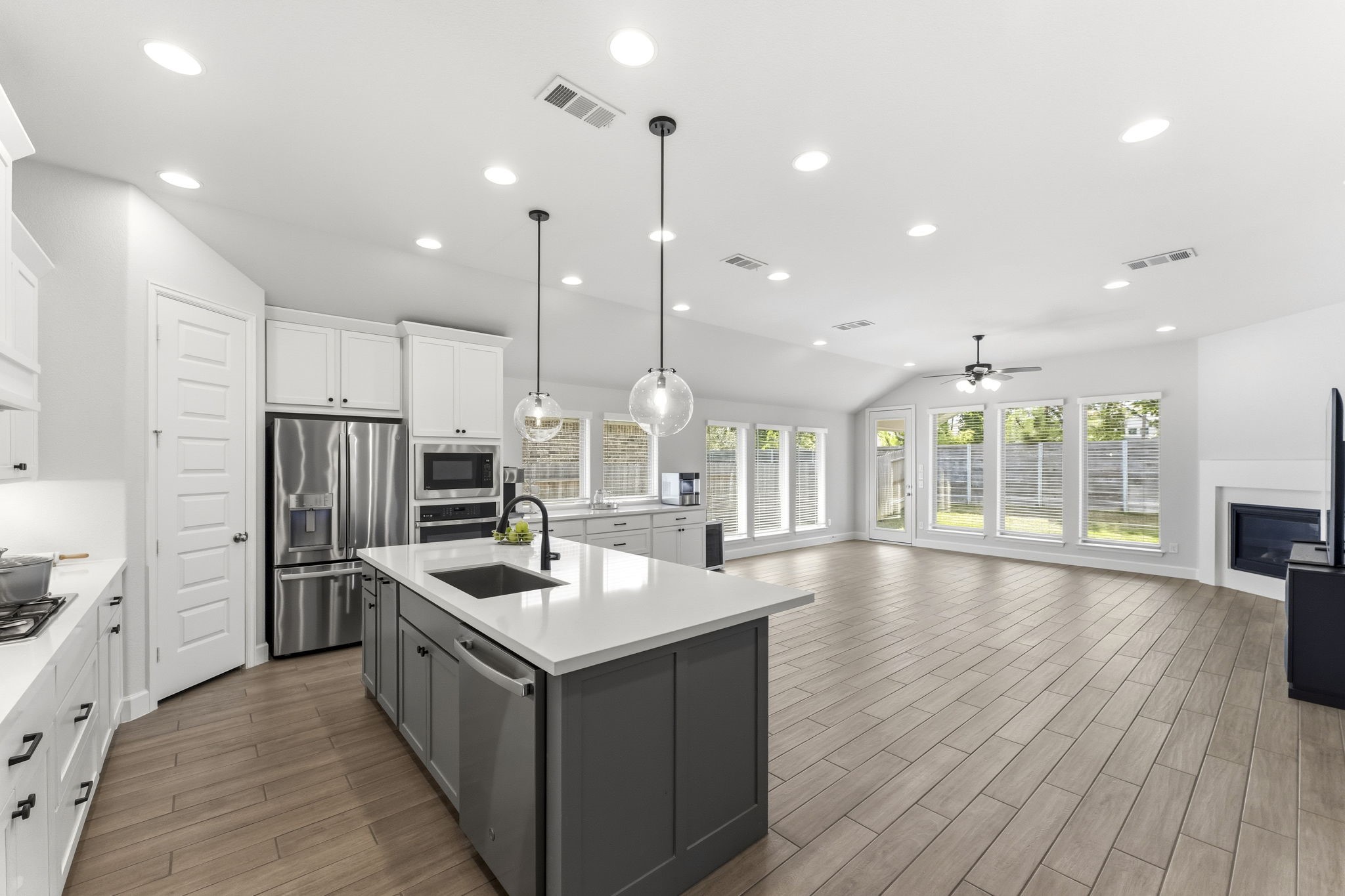 15618 Turtlehead Trail Conroe, TX 77302 - Photo 2 of 50 REFRIGERATOR INCLUDED! Open Concept Living, Quartz Island Kitchen and Wood Look Tile Throughout