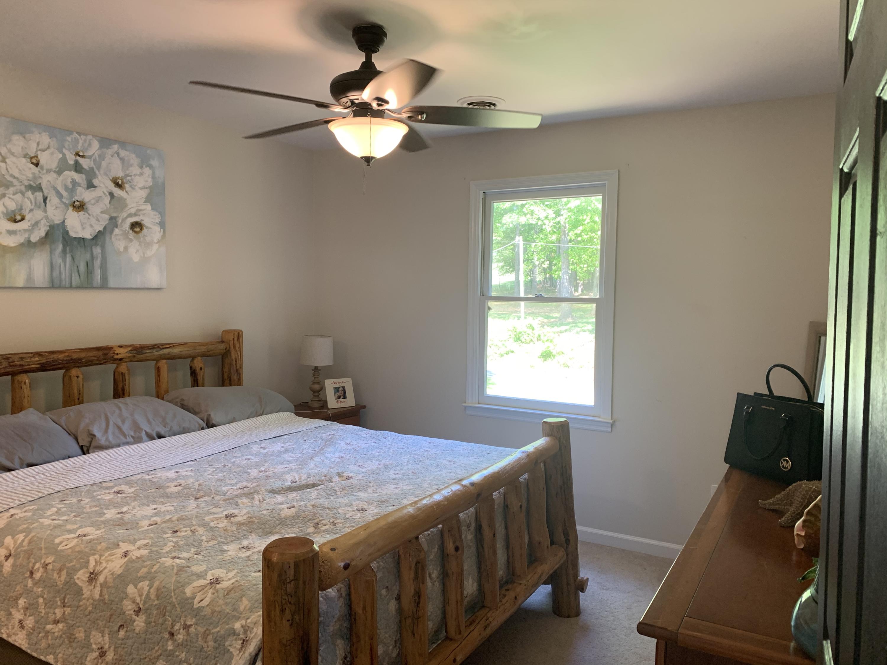 357 London Ridge Road Boones Mill, VA 24065 - Photo 16 of 28 a bedroom with a bed and a chandelier
