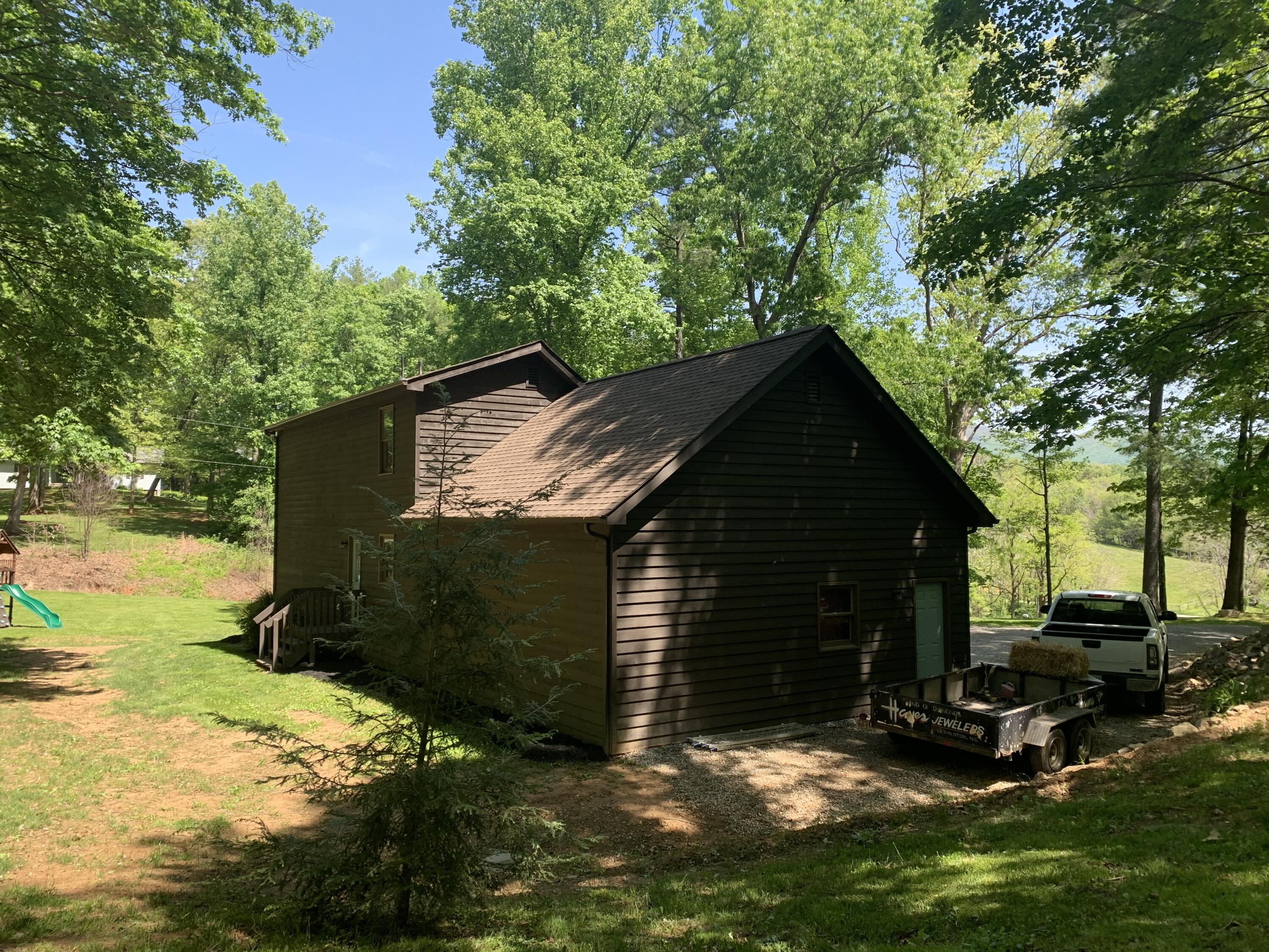 357 London Ridge Road Boones Mill, VA 24065 - Photo 25 of 28 a view of backyard with a barn and a large tree