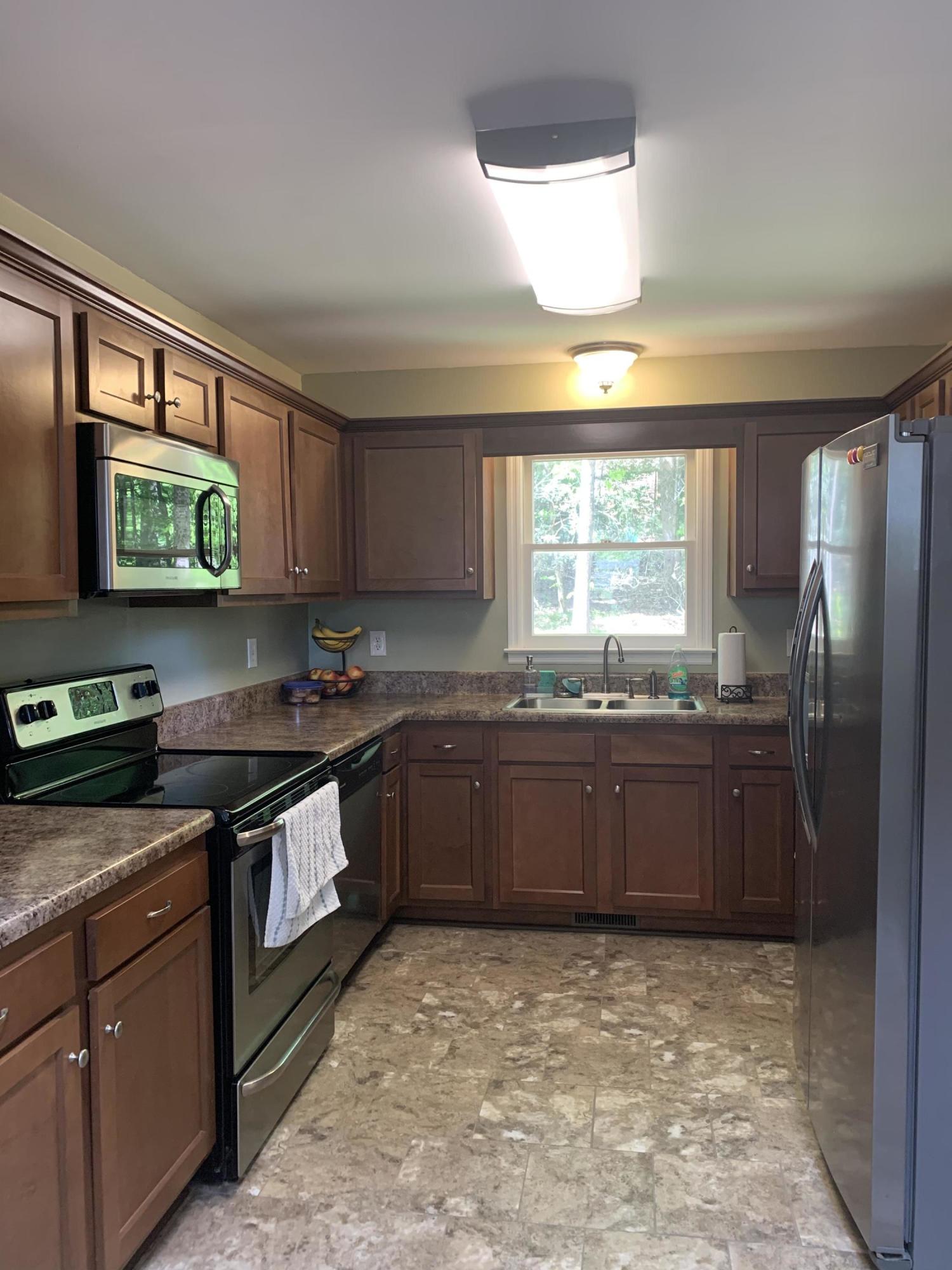 357 London Ridge Road Boones Mill, VA 24065 - Photo 5 of 28 a kitchen with stainless steel appliances granite countertop a stove a sink and a microwave