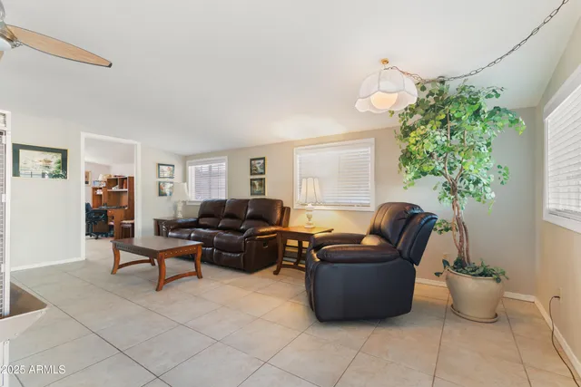 a living room with furniture potted plant and a window