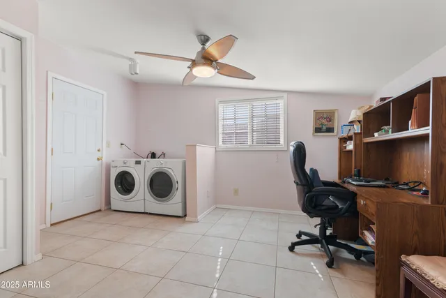 a view of a livingroom with workspace and a window