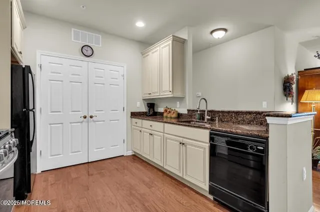 a kitchen with stainless steel appliances granite countertop a stove a microwave and a refrigerator