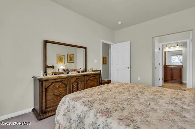 a bathroom with a toilet a sink and a mirror