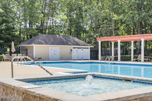 a view of a house with pool and a yard