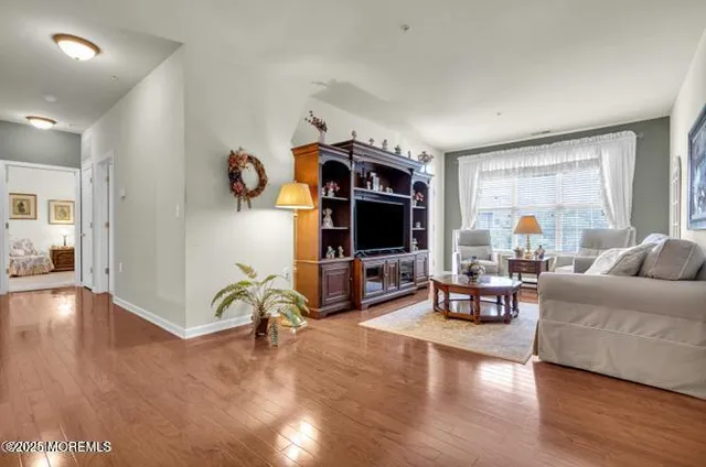 a living room with furniture large window and lamp