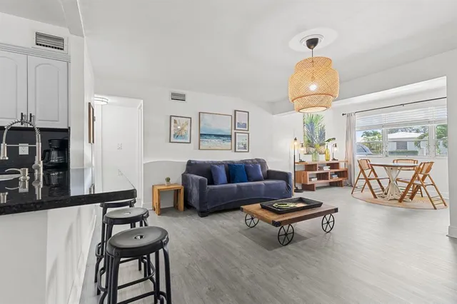 a living room with furniture and a chandelier