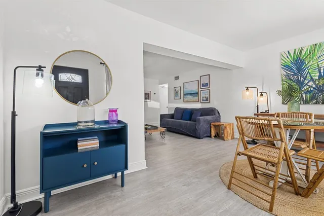 a living room with furniture a piano and a window