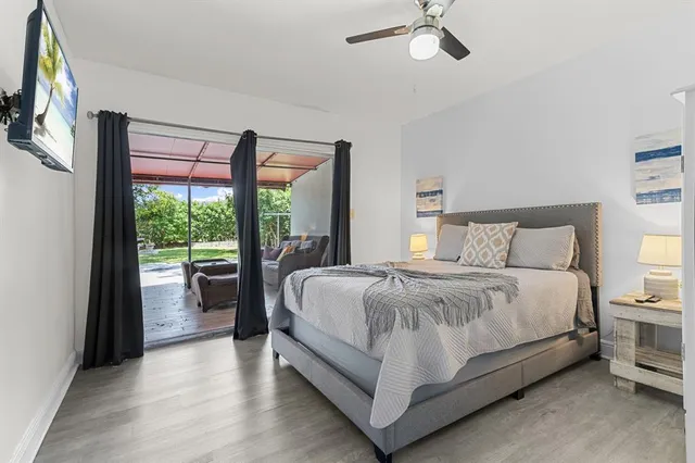 a large bed sitting in a bedroom next to a window